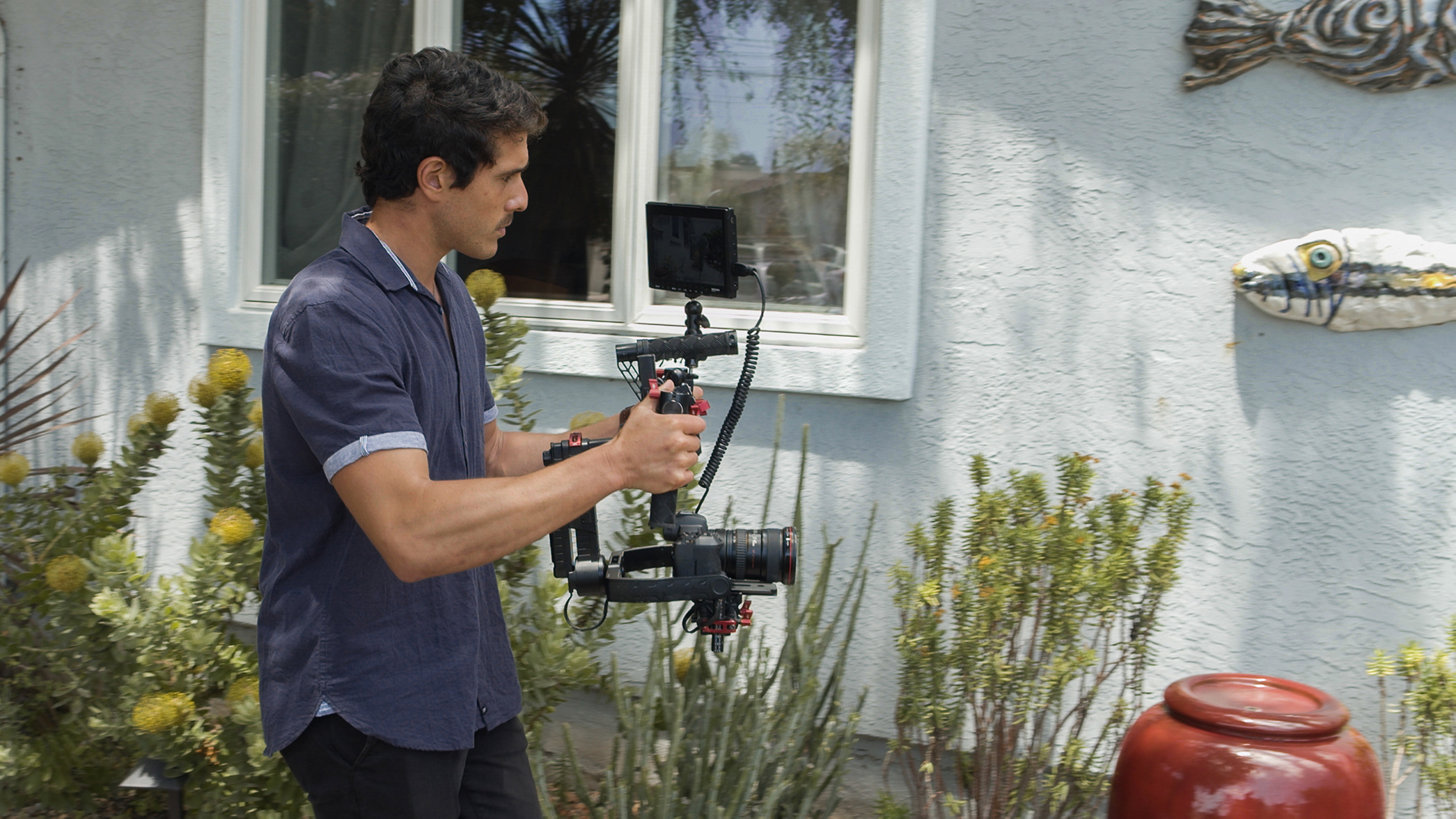 Man walking and filming house exterior