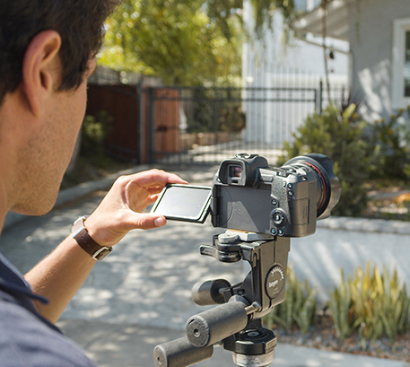 Man editing photos and uploading them to Full Frame Systems